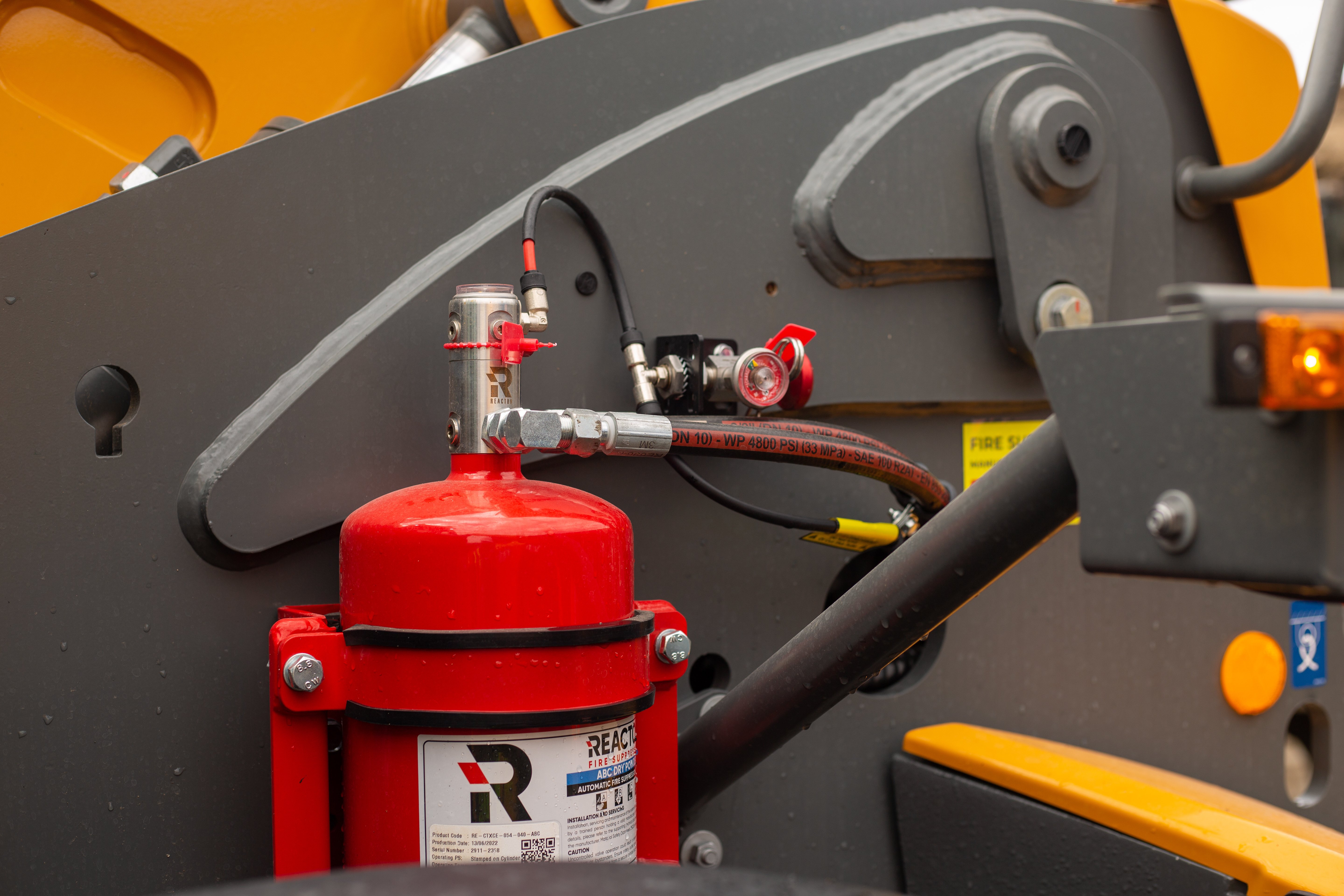 Reacton fire suppression cylinder with branding and fittings. 